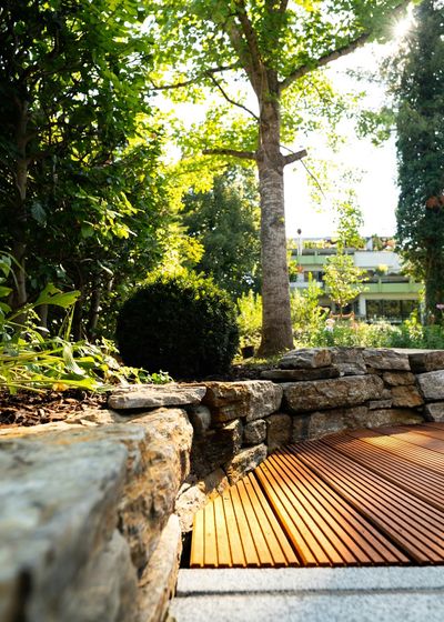 Natural stone retaining wall with hardwood decking