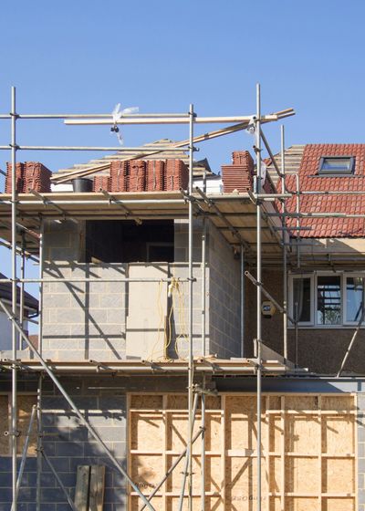 Two-storey extension in blockwork with clay-tile roofs alongside