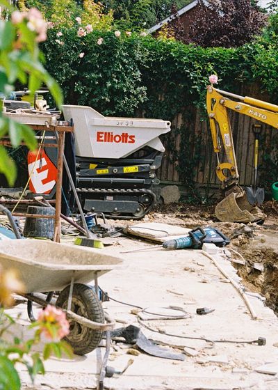 Garden excavation with a dumper and wheelbarrow